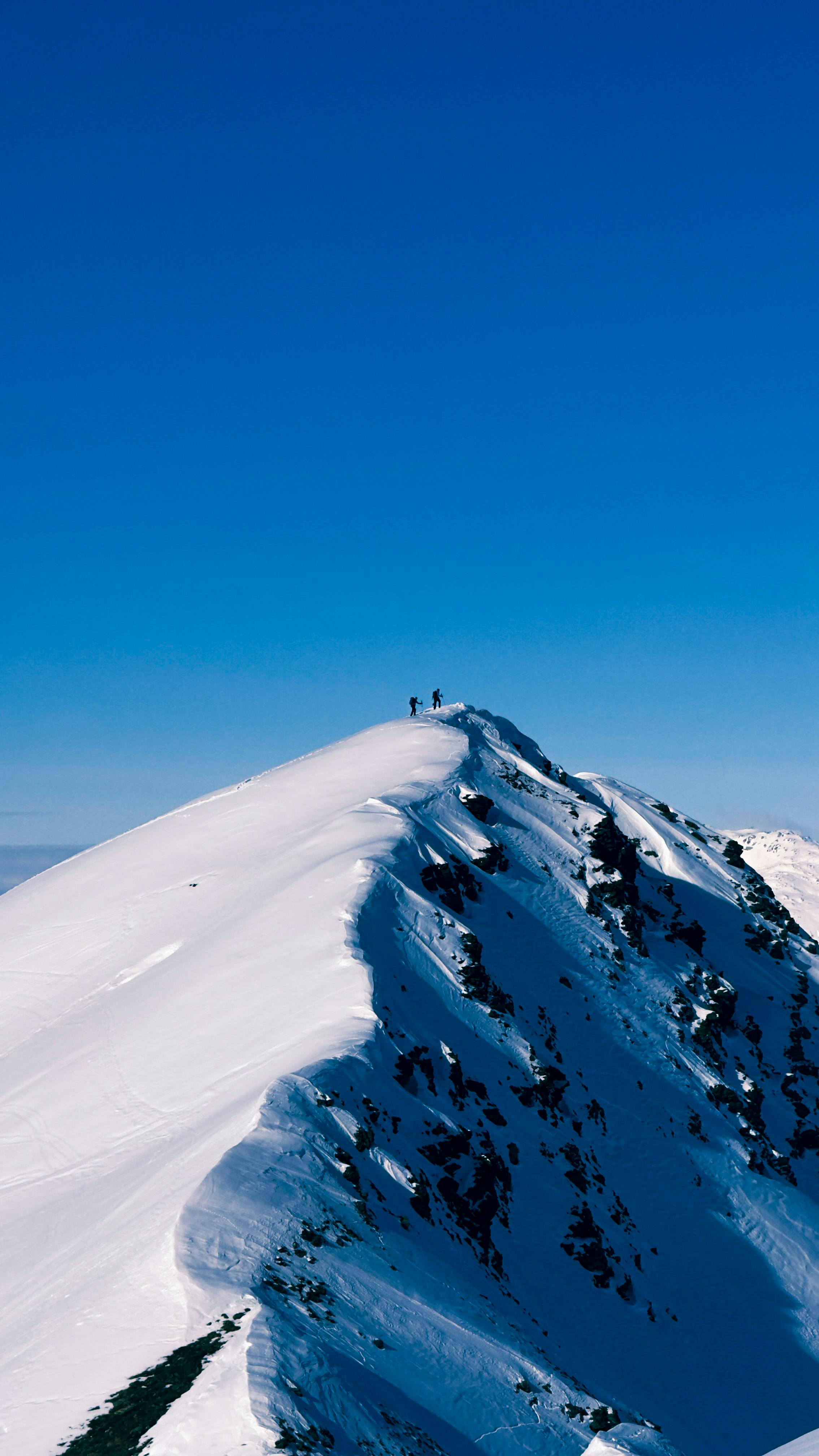 Alpine ridge with bright snow and blue sky, high altitude landscape