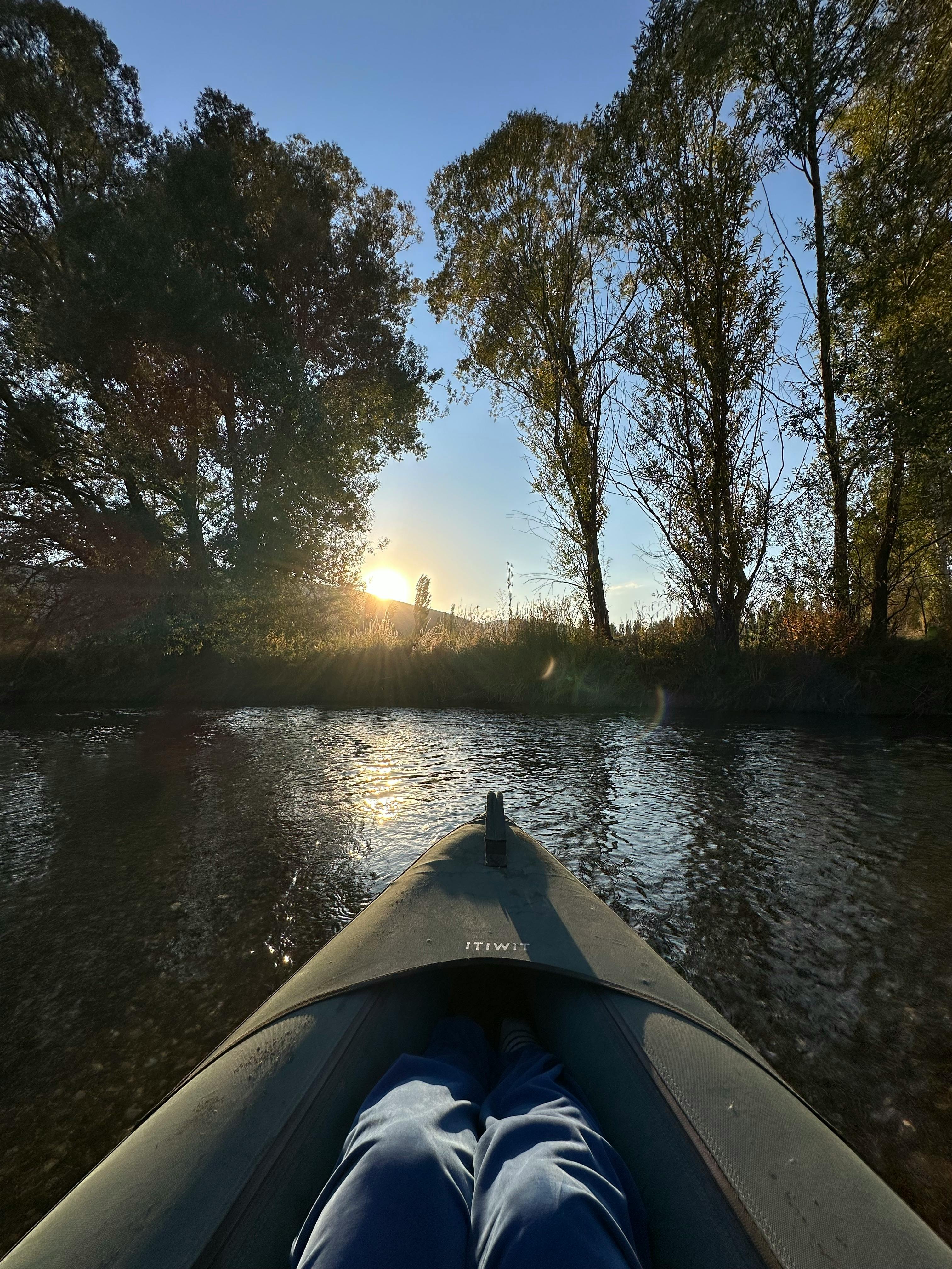 Kayak on calm river water in morning light