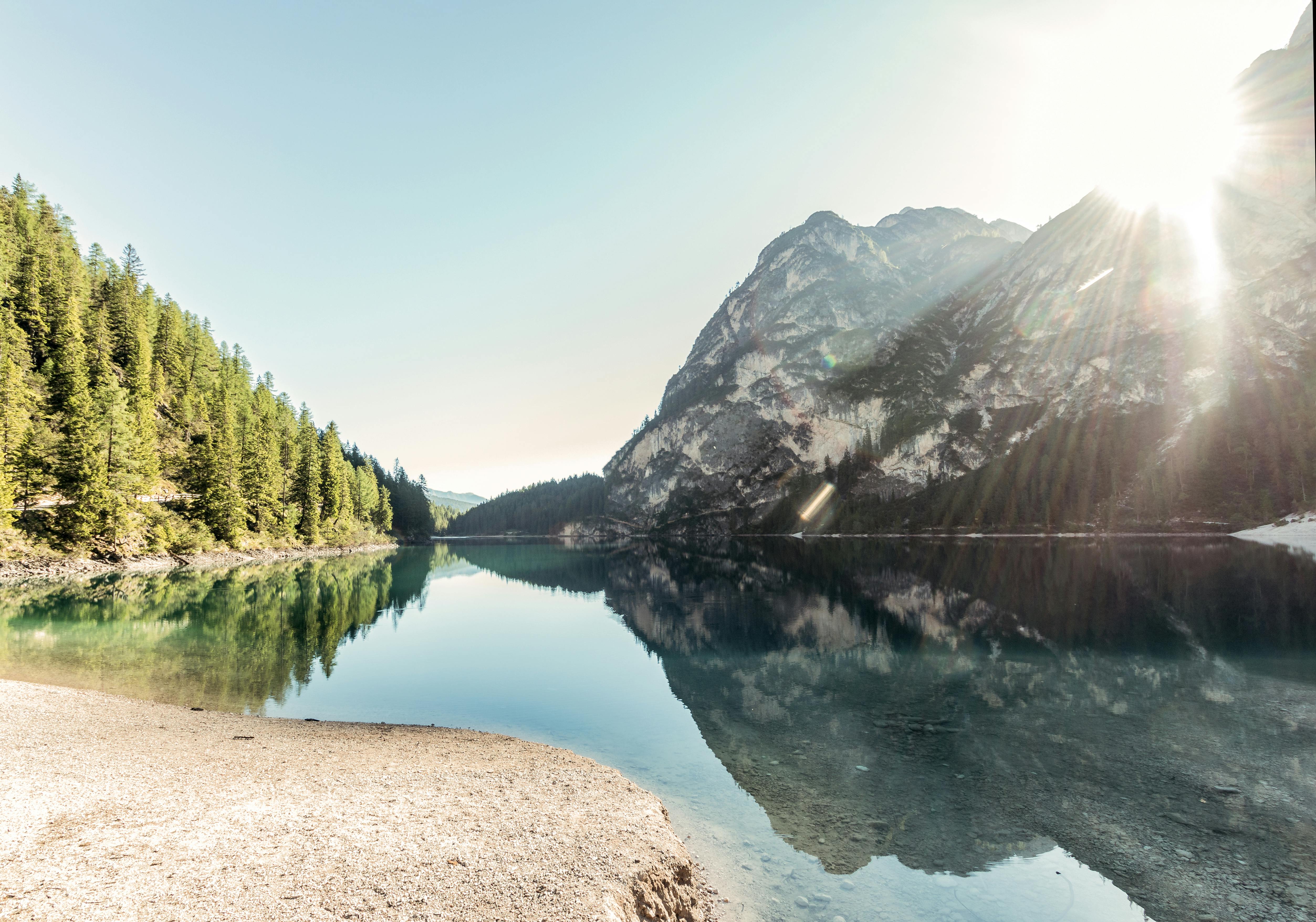 View of a mountain lake with visible glare on the water surface