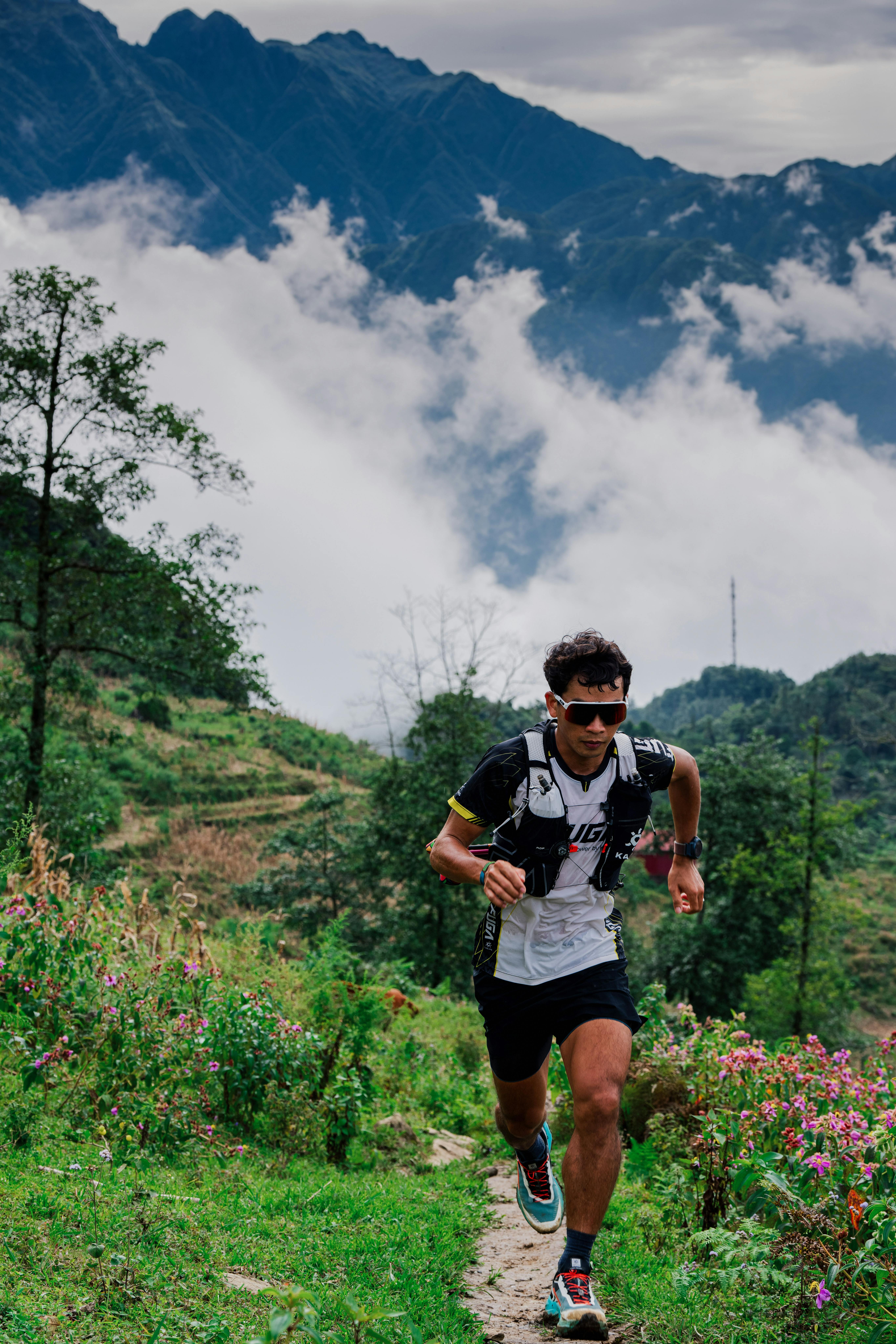 Trail runner on a mountain path in bright conditions